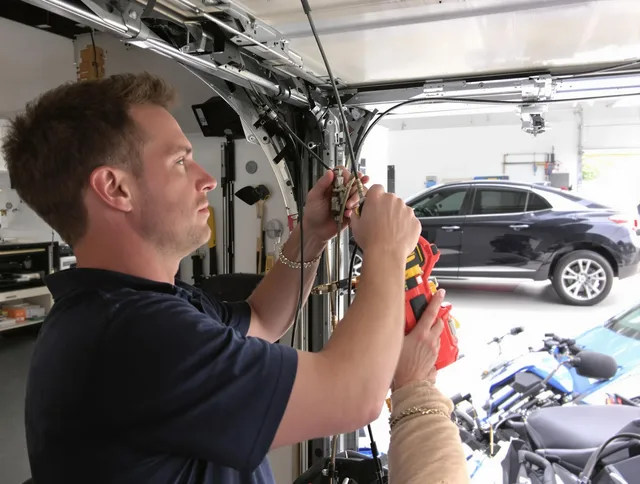 Ellington Garage Door Repair safety certified technician performing cable replacement in Ellington