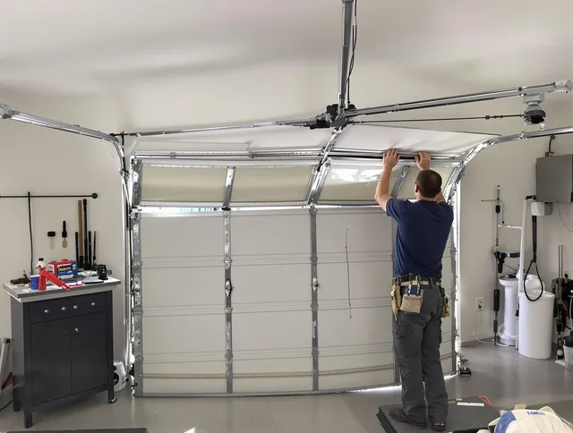 Ellington Garage Door Repair specialist performing precise section replacement on Ellington garage door